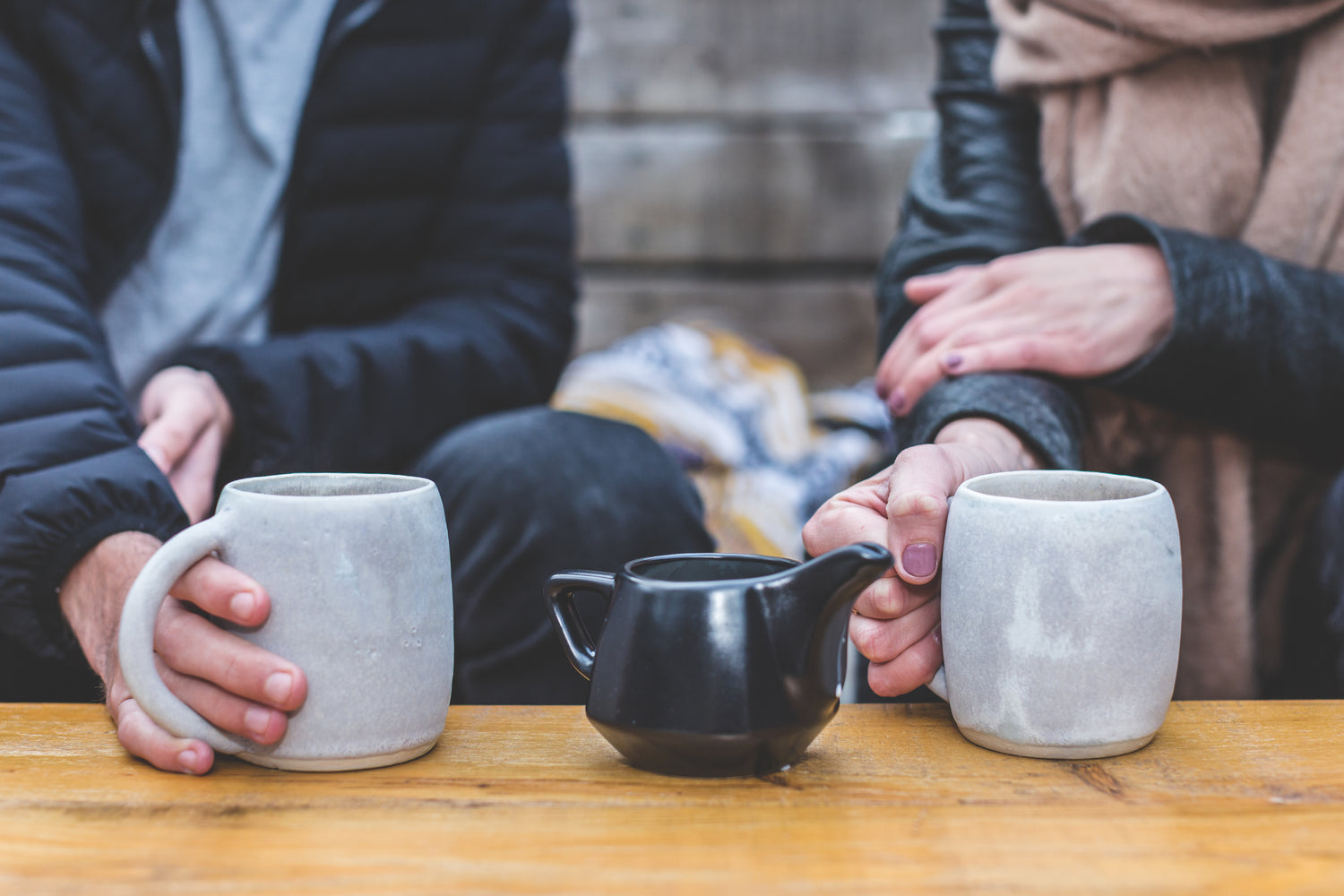 Two Persons Enjoying A Conversation With A Coffee